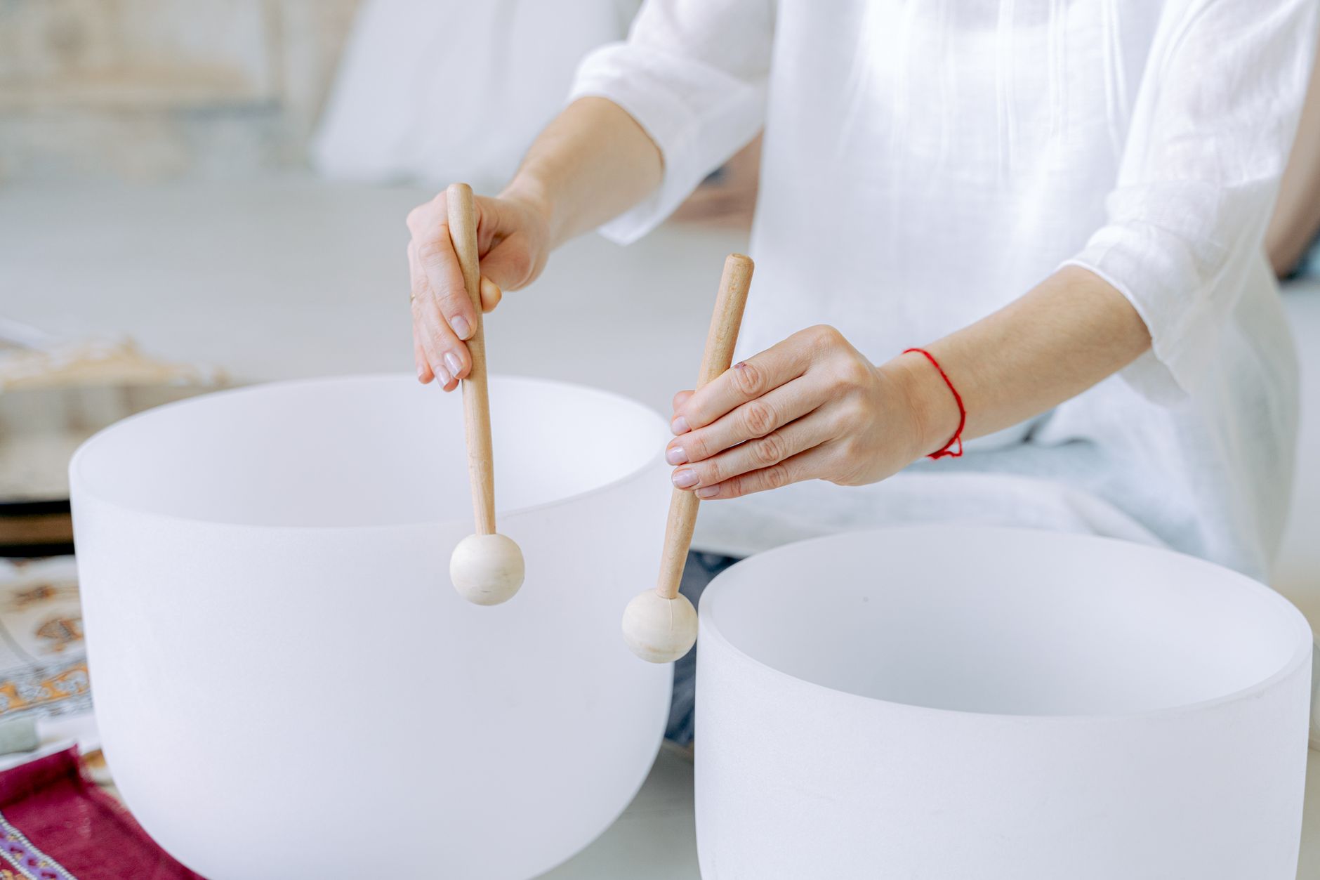 Hands holding Tibetan singing bowl during meditation session
