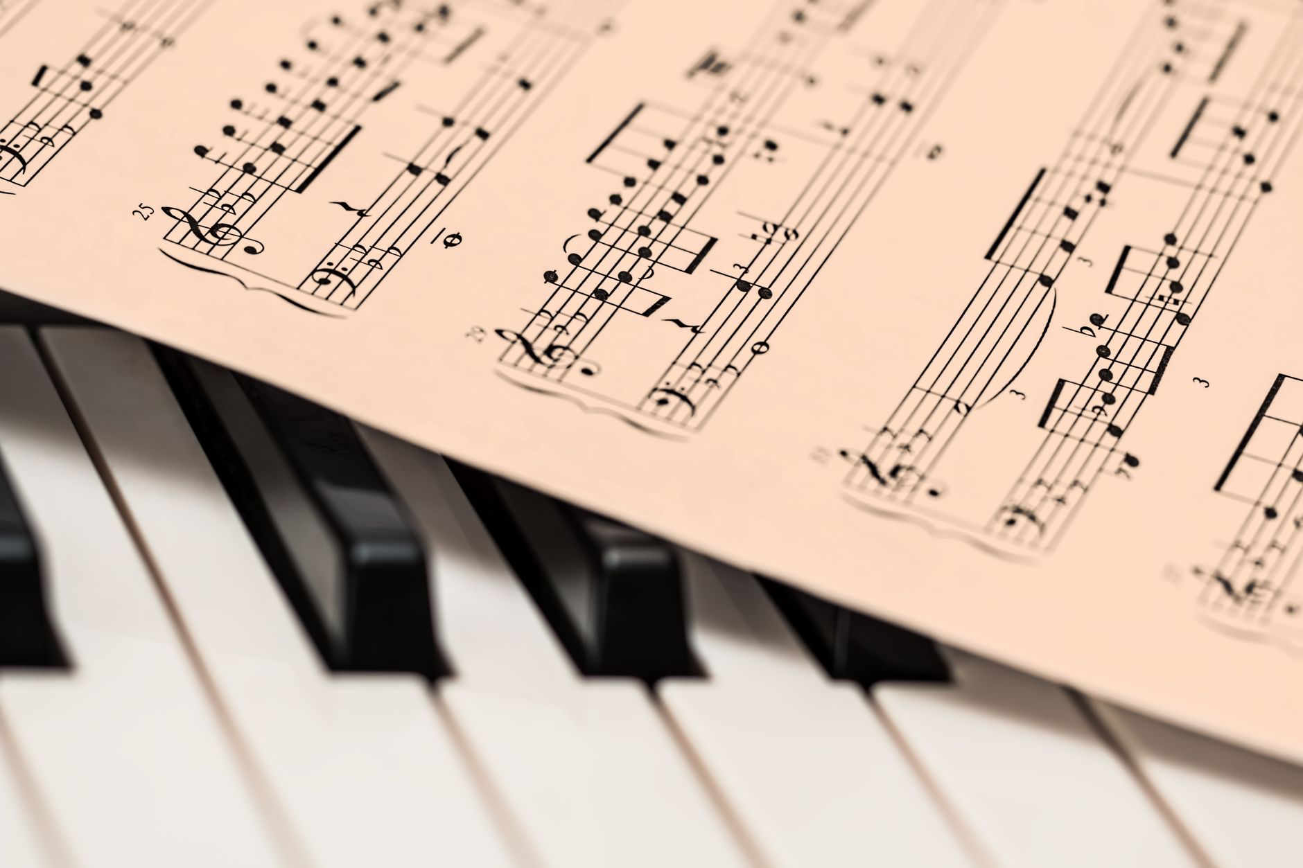 Person learning to play songs on the otamatone with audio reference and sheet music
